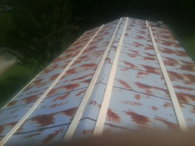 Rusted metal roof panels with new wood purlins before replacement — Storm Damage Roof Repair in Pine Valley by Roofing Brothers
