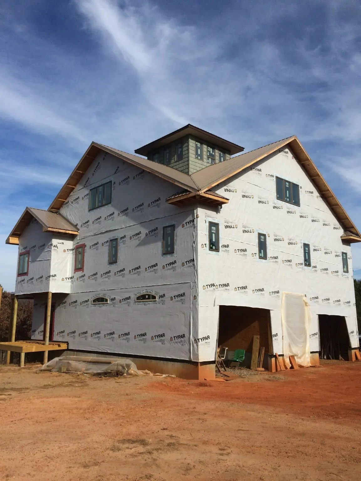 New two story house under construction with a cupola and gabled roofs in Pine Valley